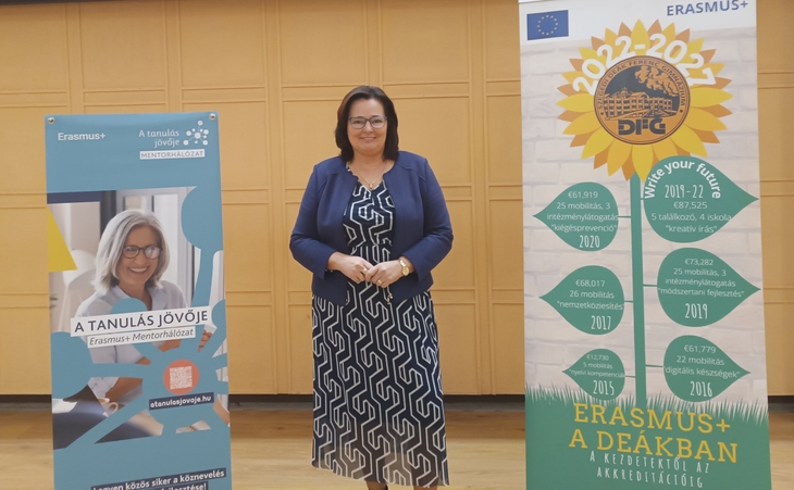 Farag&oacute; Kl&aacute;ra Erasmusplusz mentor Mentorh&aacute;l&oacute;zat &eacute;s Erasmus poszter előtt fot&oacute;zkodik